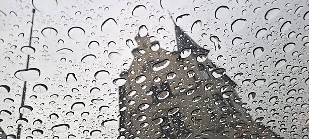 Abstract image, old building through glass with raindrops, waterdrops, blurred