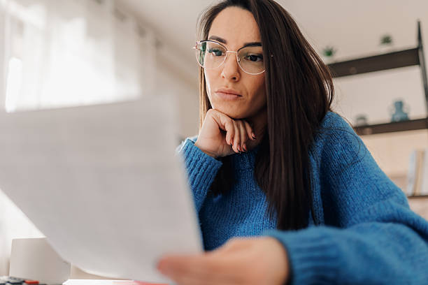 istock Focused businesswoman reading documents at home office, working remotely 2208938477
