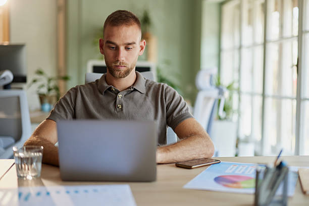 istock Young creative man working on laptop in the office. 2208939261