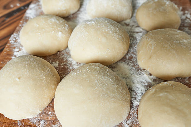 istock Raw buns on a cutting board with flour. Selective focus. 2208939398