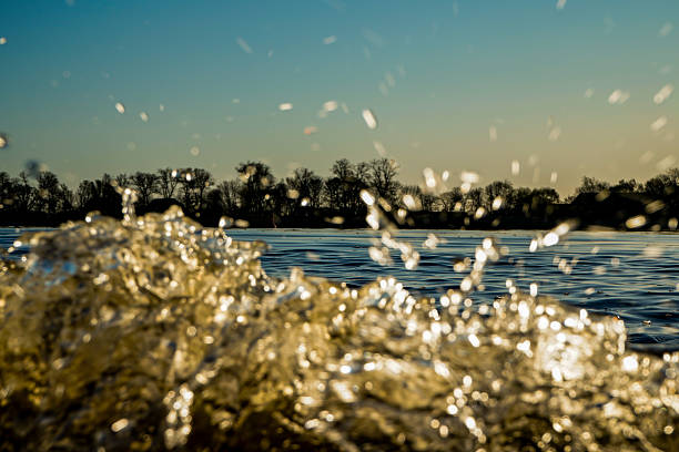 istock Close-focused water movement shows splashing water and reflection under the sun 2208941693