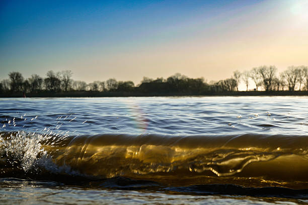 Waves charge up to splash against the shore, Weserstrand 26931 Oberhammelwarden-Germany
