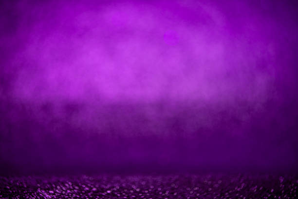 Fancy purple glitter sparkle background.Defocused purple sequin light. Fancy blue glitter sparkle background. Studio shooting of a creative bright magenta color background. It is textured color gradient. There are no text and no people, and have copy space for design. Its Suitable for commercial use. Christmas, New Year, Diwali festive celebrations themed backgrounds, wallpapers, templates for greeting cards, banners and posters and wrapping paper is apt.