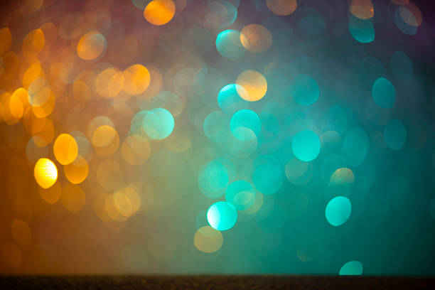 Defocused golden sequin light. Fancy gold glitter sparkle background. Studio shooting of a creative bright yellow color background. It is textured color gradient. There are no text and no people, and have copy space for design. Its Suitable for commercial use. Christmas, New Year, Diwali festive celebrations themed backgrounds, wallpapers, templates for greeting cards, banners and posters and wrapping paper is apt.