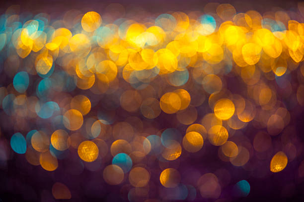 Defocused golden sequin light. Fancy gold glitter sparkle background. Studio shooting of a creative bright yellow color background. It is textured color gradient. There are no text and no people, and have copy space for design. Its Suitable for commercial use. Christmas, New Year, Diwali festive celebrations themed backgrounds, wallpapers, templates for greeting cards, banners and posters and wrapping paper is apt.
