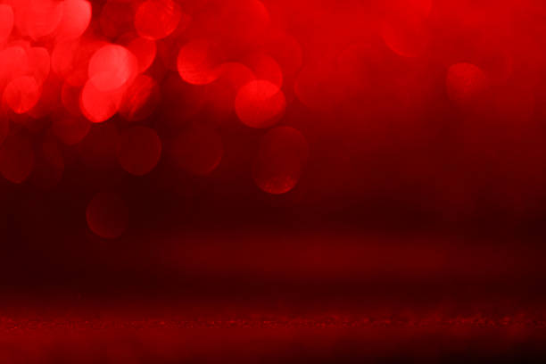 Fancy red glitter sparkle background. Defocused pink sequin light. Fancy red glitter sparkle background. Studio shooting of a creative bright magenta color background. It is textured color gradient. There are no text and no people, and have copy space for design. Its Suitable for commercial use. Christmas, New Year, Diwali festive celebrations themed backgrounds, wallpapers, templates for greeting cards, banners and posters and wrapping paper is apt.