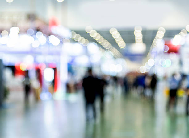 istock Abstract defocused crowd of people walking in exhibition 2208944009