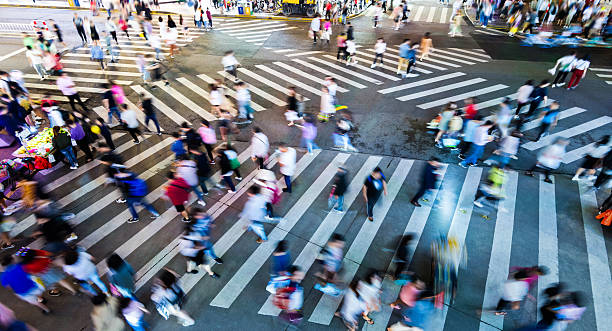 istock Motion blurred crowd of people walking on crosswalk 2208944125