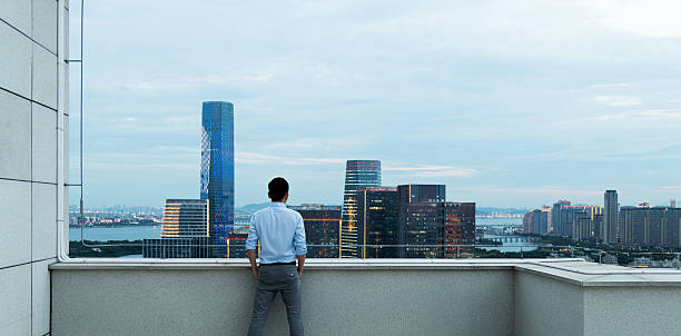 istock Businessman looking at cityscape on the rooftop 2208944150