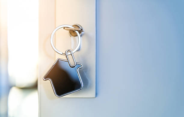 istock Open the door and door handle with a key and a house shaped silver keyring 2208944336