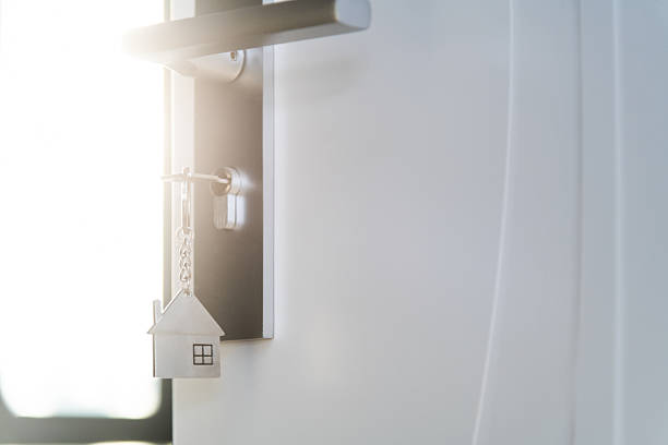 istock Open the door and door handle with a key and a house shaped silver keyring 2208944343