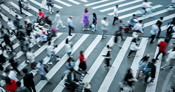 istock Motion blurred crowd of people walking on crosswalk 2208944883
