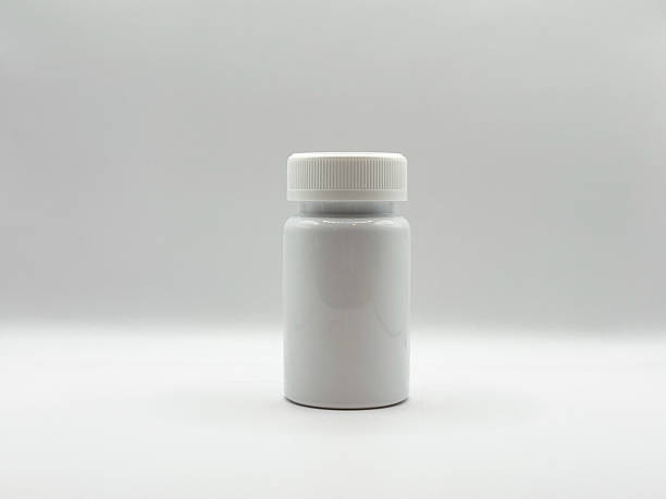 istock White medicine jar with closed lid stands on white background in center in front view image 2208945076
