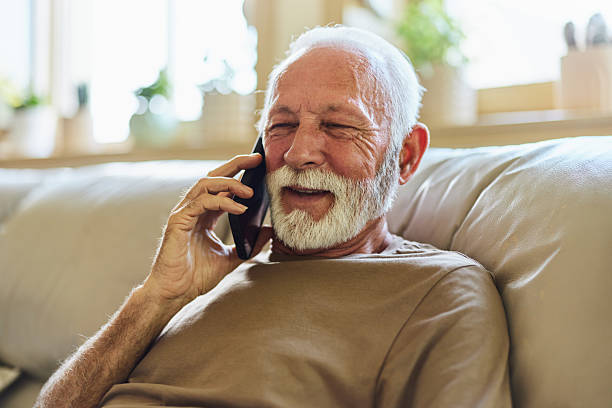 istock Happy senior man talking on mobile phone at home. 2208946779