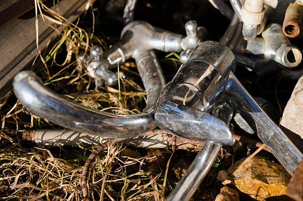 rusted faucets and other metal scrap abandoned on the ground