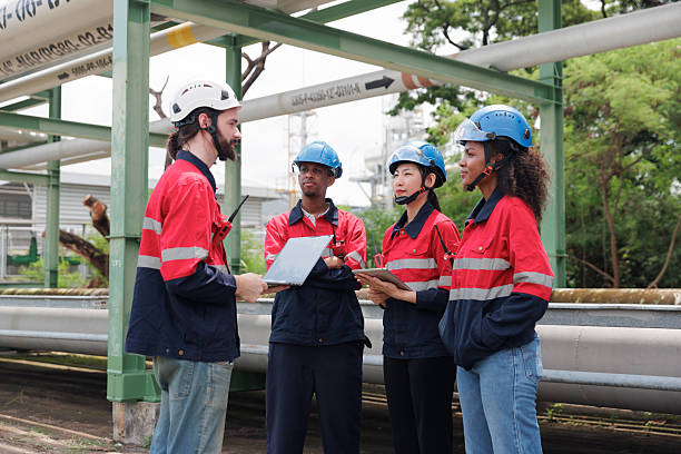 istock Group engineers work using laptop and tablet in gas refineries and oil refinery plants to check production 2208948525