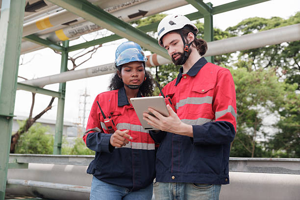 istock Group engineers work using laptop and tablet in gas refineries and oil refinery plants to check production 2208948545