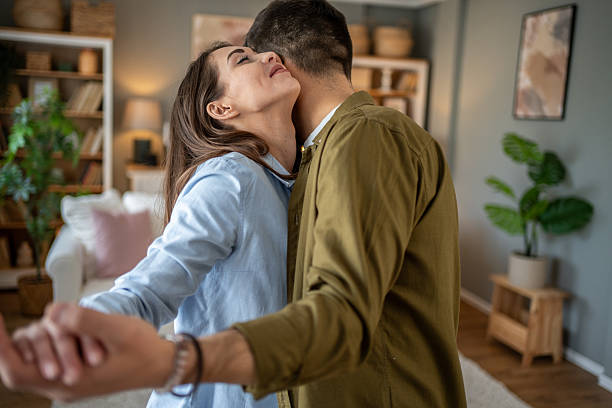 istock Romantic couple dancing at home, embracing and holding hands 2208949587
