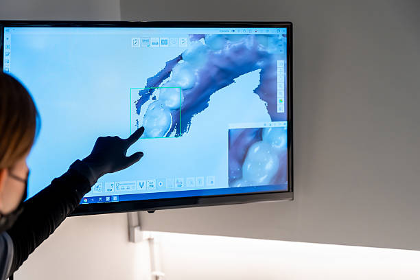 istock Dentist pointing at teeth x-ray on computer screen in dental clinic 2208953819
