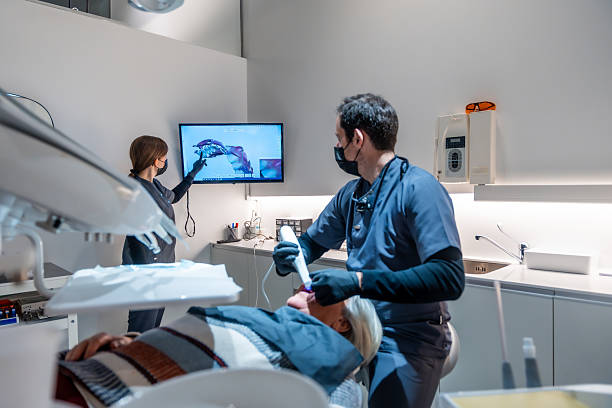 istock Dentist and assistant examining teeth x-ray in modern clinic 2208953821