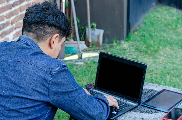 istock Focus man working from home outside with a laptop netbook tablet and mobile phone 2208955937