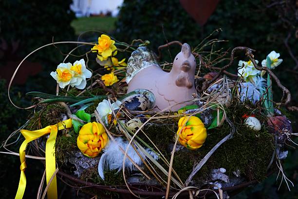 Inspired by Easter, this composition with a chicken figurine, flowers, and eggs creates a festive spring atmosphere. Bright yellow tulips and daffodils add freshness and softness to the decor.