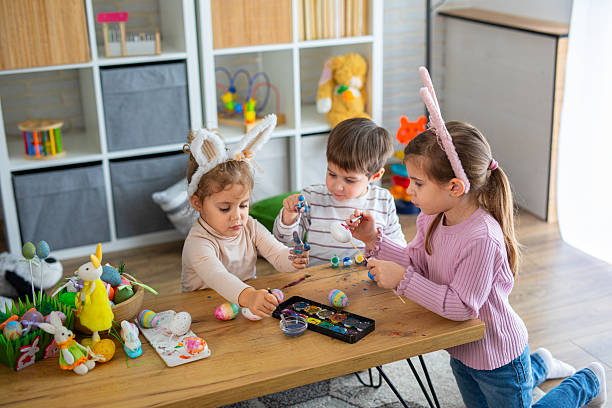 istock Little kids painting eggs for Easter holiday 2208960759