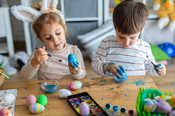 istock Two little kids painting eggs for Easter holiday 2208960869