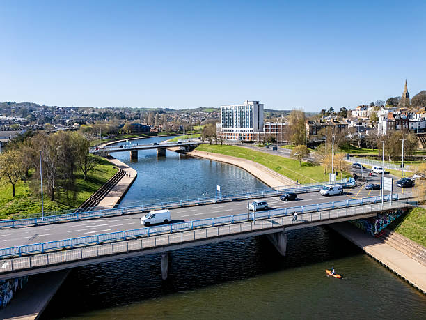Exeter, UK. 6 April 2025. Kayaker goes under a bridge on River Exe in Exeter