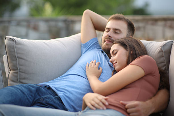istock Couple sleeping lying in an exterior sofa 2208962659