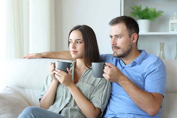 istock Relaxed couple drinking tea and relaxing at home 2208962757