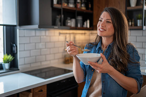 istock Young woman enjoying a healthy breakfast in modern kitchen 2208963293