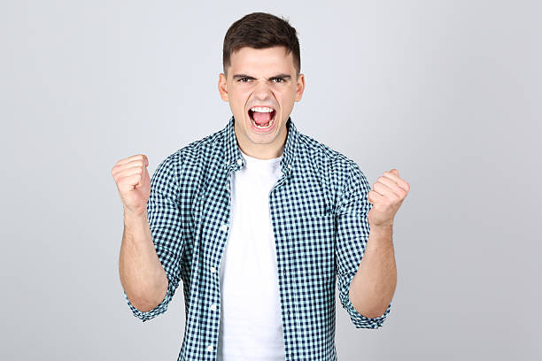 istock Young emotional man on grey background 2208965761