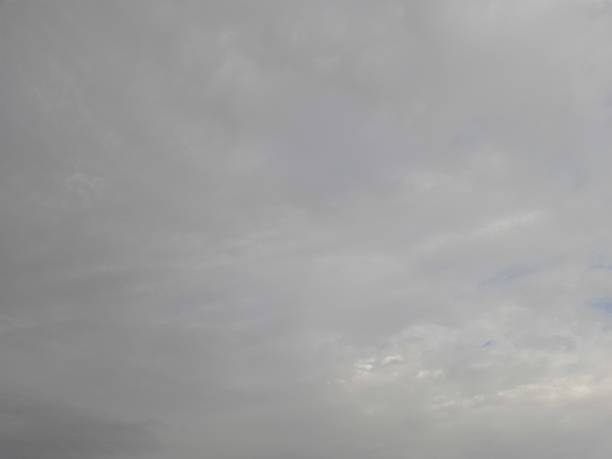 Gray clouds before rain and sun behind the cloud.