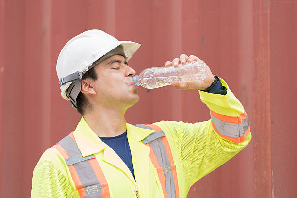 istock Drinking water,  worker and container cargo site. Male container yard worker break and drinking water at container cargo yard 2208966612