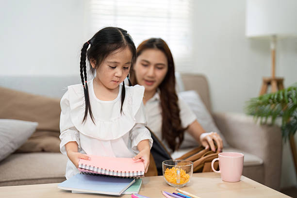 istock Studying and Exploring Creativity. A child organizes her school supplies, assisted by her mother as they prepare for the school year. 2208967507