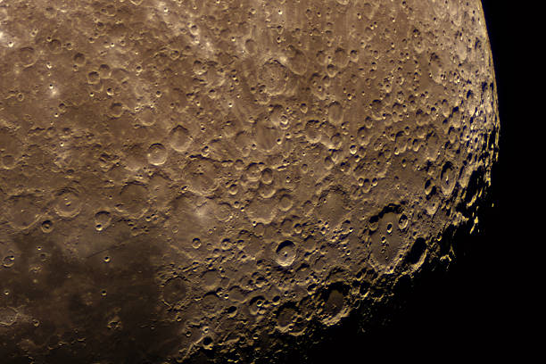 Partly illuminated moon in the dark night sky over Western Europe on January 18, 2024. The surface of the moon is clearly visible with various craters and seas.