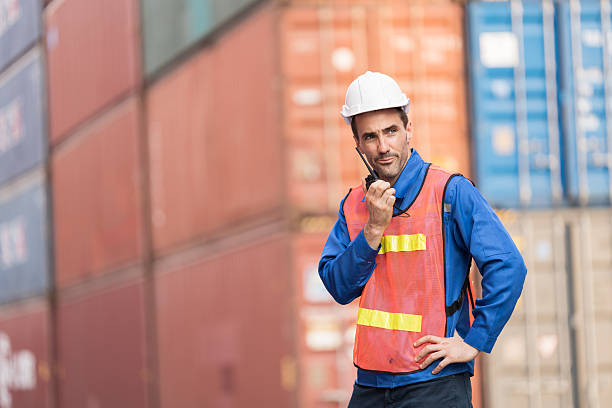 istock Import and export container, Worker inspecting and control of container. Male worker working and managing container at container yard 2208967847