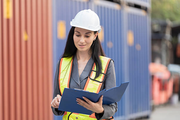 istock Import and export container, Worker inspecting and control of container. Woman worker working and managing container at container yard 2208968909