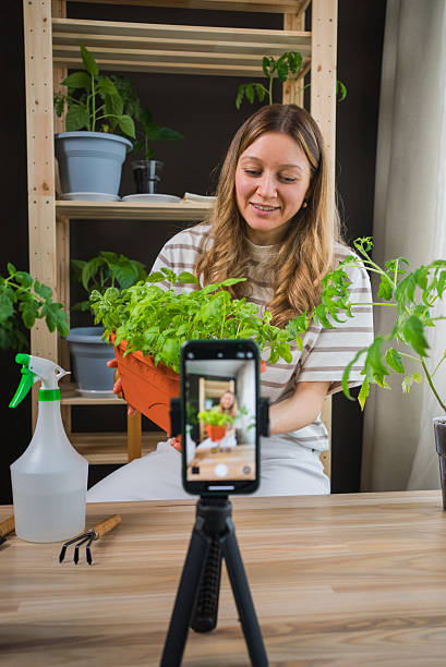 istock Influencer creating online gardening content with smartphone and tripod 2208969459