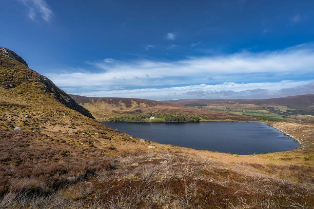 istock A Serene Lake That is Completely Surrounded by Beautiful Rolling Hills Beneath a Clear and Bright Blue Sky 2208976559