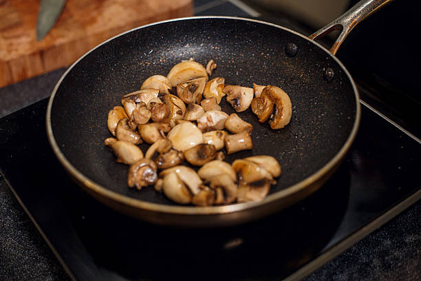 pan frying champignon mushrooms. High quality photo