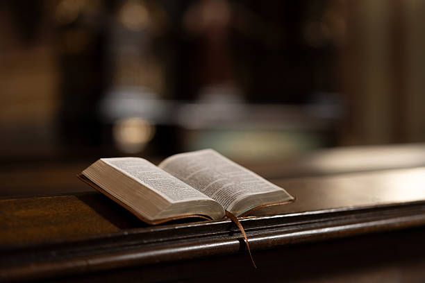 istock Open Bible on Wooden Church Lectern 2208977544