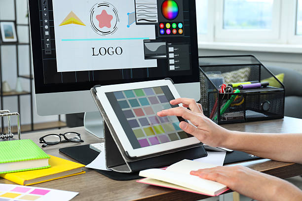 istock Designer working on tablet at wooden table indoors, closeup 2208978641
