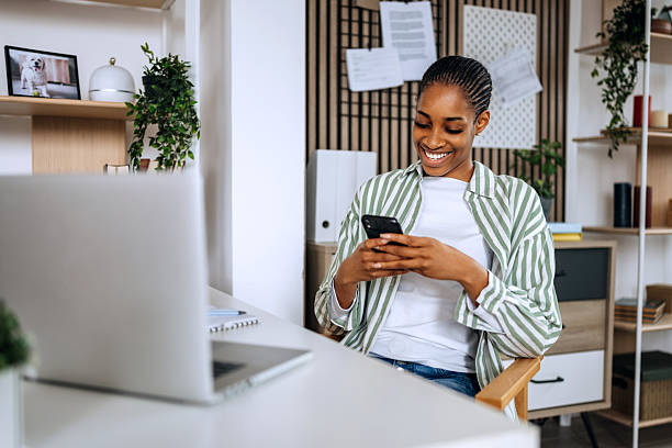 istock Young woman working from home and texting on smartphone 2208978786