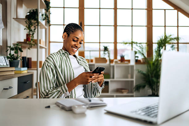 istock Young woman working from home and texting on smartphone 2208978787