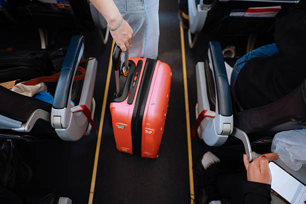 istock Interior of airplane with people sitting on seats 2208985140