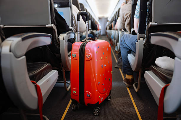 istock Interior of airplane with people sitting on seats 2208985328