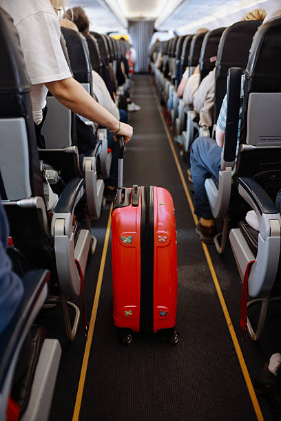 istock Interior of airplane with people sitting on seats 2208985689