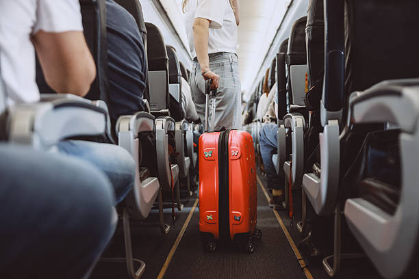 istock Interior of airplane with people sitting on seats 2208985764